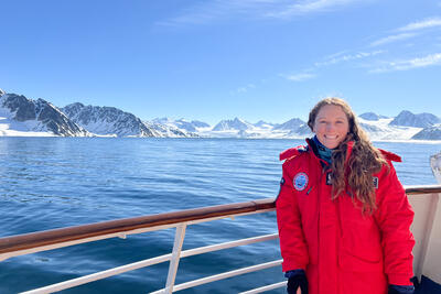 Jenna posing on the front of the Sea Spirit cruise ship in Svalbard